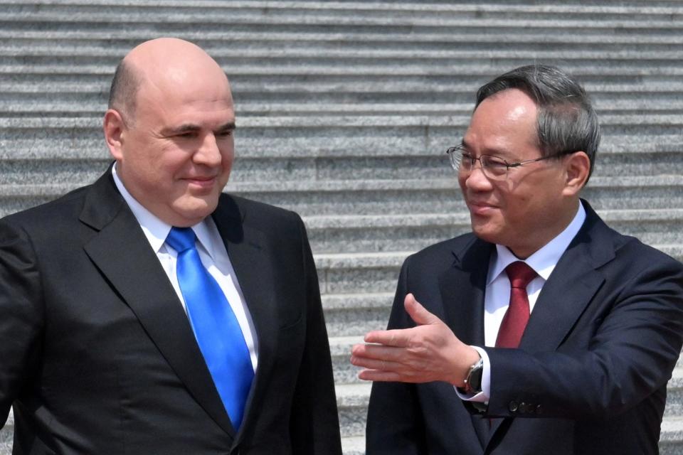 Russian Prime Minister Mikhail Mishustin, left, and Chinese Premier Li Qiang attend a welcoming ceremony in Beijing, China, Wednesday, May 24, 2023. (Alexander Astafyev, Sputnik, Government Pool Photo via AP)