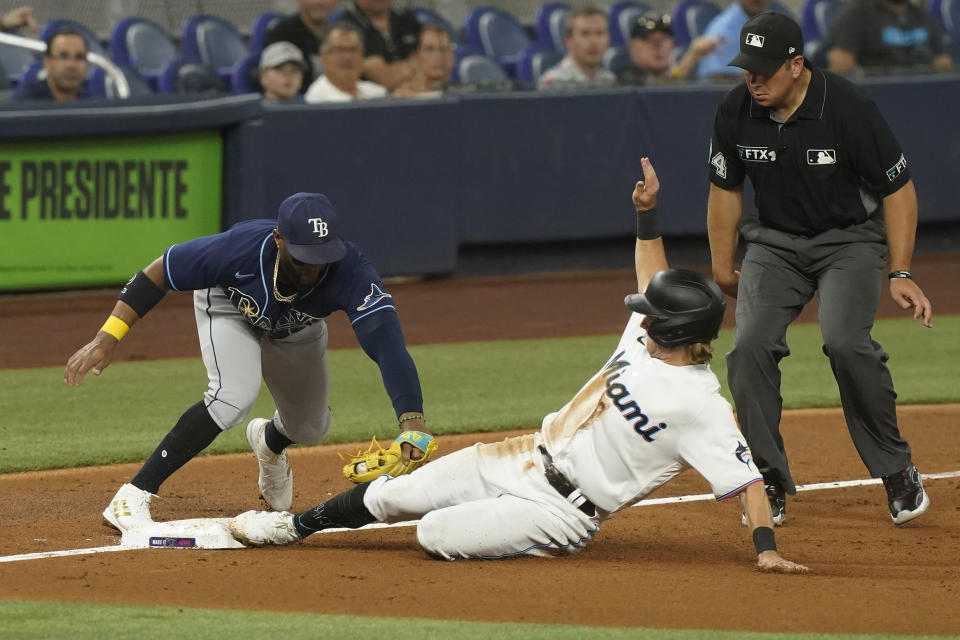 Tampa Bay Rays third baseman Yandy Diaz tags Miami Marlins' Luke Williams during the third inning of a baseball game, Tuesday, Aug. 30, 2022, in Miami. (AP Photo/Marta Lavandier)