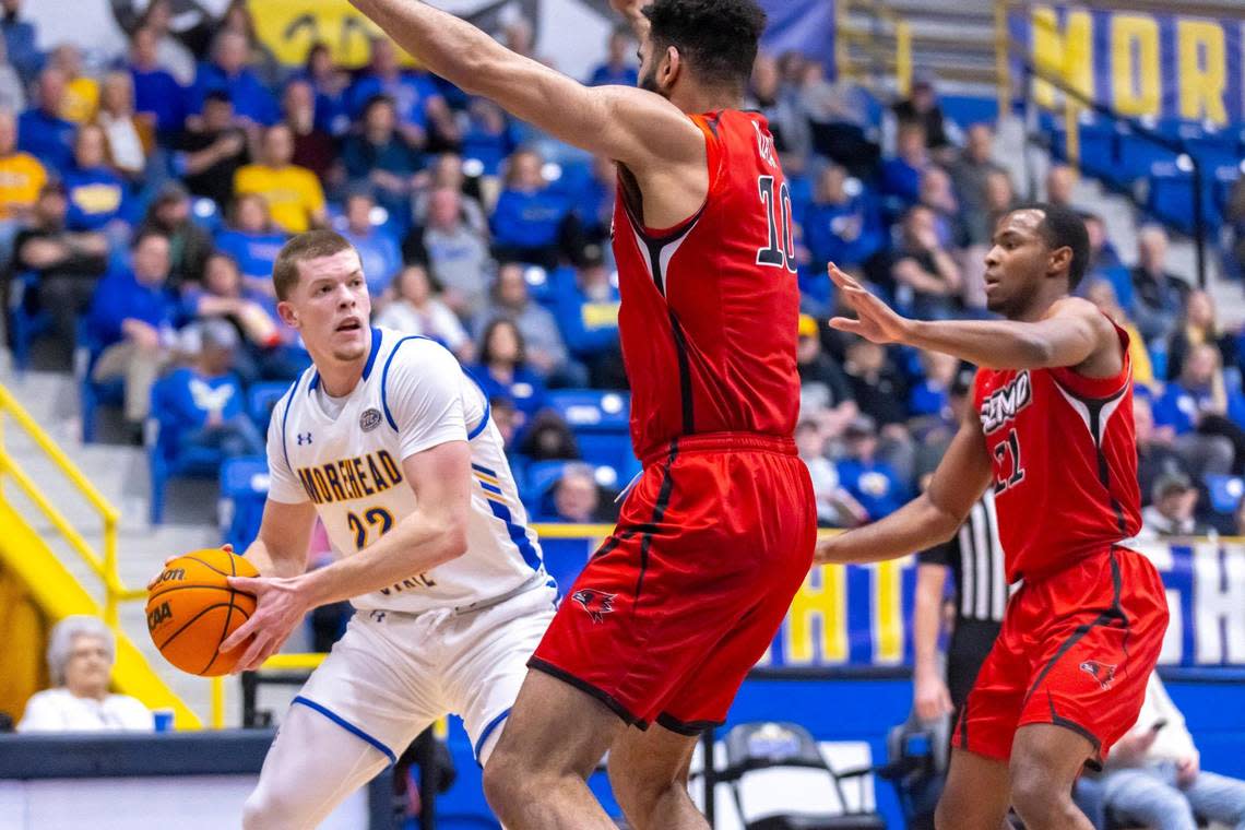 Morehead State Eagles guard Riley Minix (22) is guarded by Southeast Missouri State Redhawks center David Idada (10) and Southeast Missouri State Redhawks guard Evan Eursher (11) during a game at Johnson Arena in Morehead, Ky., on Thursday, Feb. 29, 2024. Minix was named the 2024 Ohio Valley Conference Player of the Year in his first season playing NCAA Division I basketball.