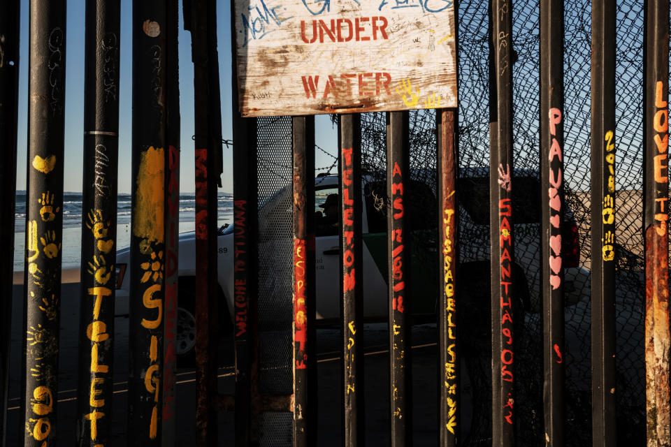 In this Jan. 2, 2019, photo, a border patrol office inside his vehicle guards the border fence at the U.S. side of San Diego, Calif., as seen from Tijuana, Mexico. As the U.S. government remains shut down over President Donald Trump’s insistence on funding for his border wall, nearly half of Americans identify immigration as a top issue for the government to work on this year. (AP Photo/Daniel Ochoa de Olza)