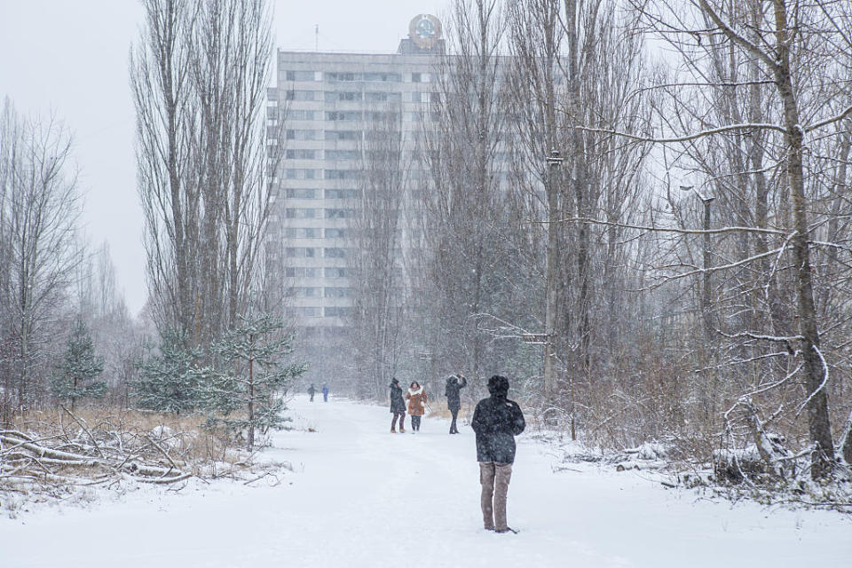 <p>People take pictures in the town of Pripyat (Getty Images) </p>