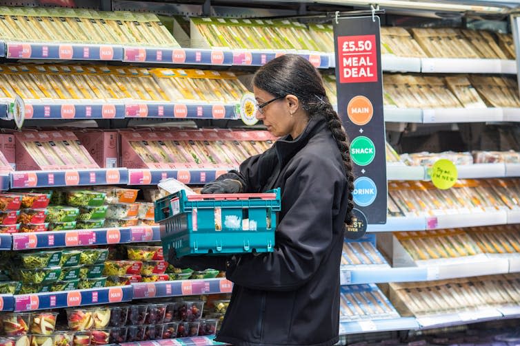 A shop worker stacking shelves.