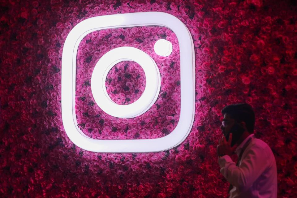 A man talks on the mobile phone next to a logo of Instagram, during a Meta event in Mumbai, India, 20 September, 2023. (Photo by Niharika Kulkarni/NurPhoto via Getty Images)
