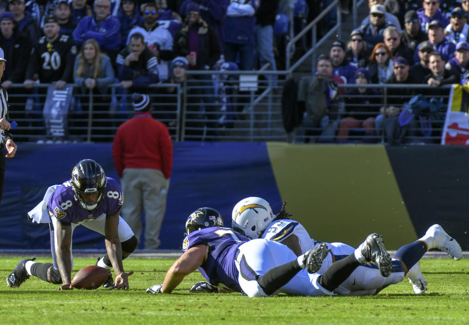 <p>Baltimore Ravens quarterback Lamar Jackson (8) recovers his own fumble in the first quarter agains the Los Angeles Chargers on January 6, 2019, at M&T Bank Stadium in Baltimore, MD. (Photo by Mark Goldman/Icon Sportswire) </p>