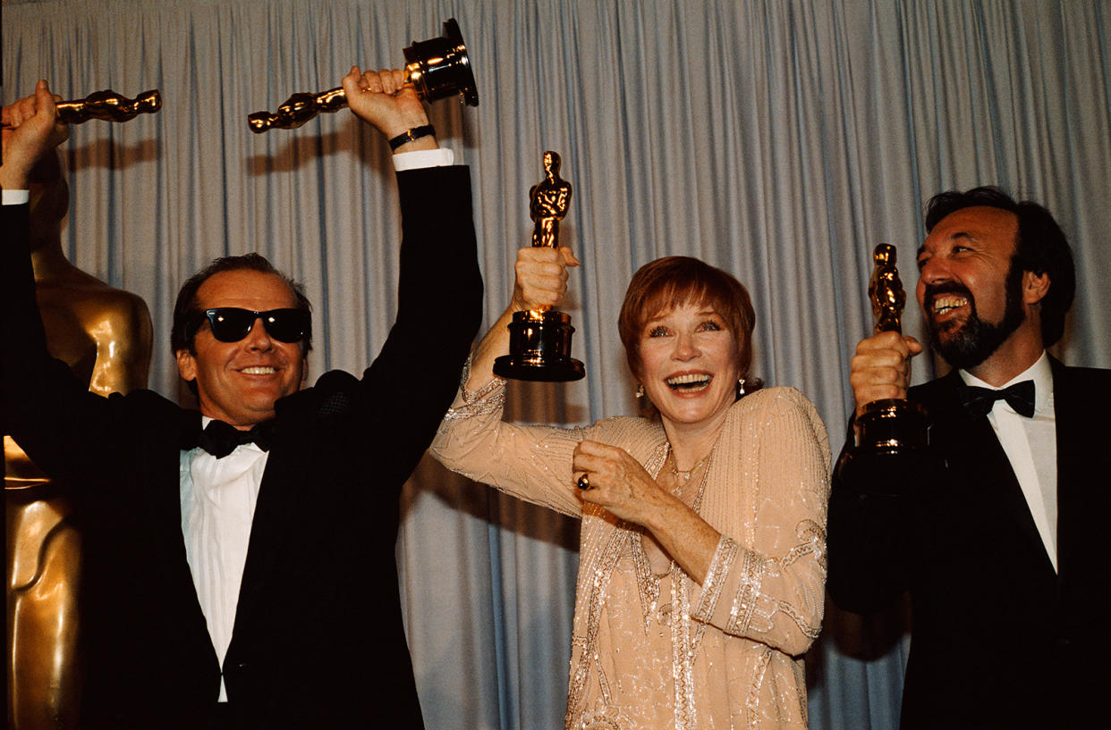 Jack Nicholson, Shirley MacLaine and James L. Brooks holding their Oscars at the 1984 Academy Awards