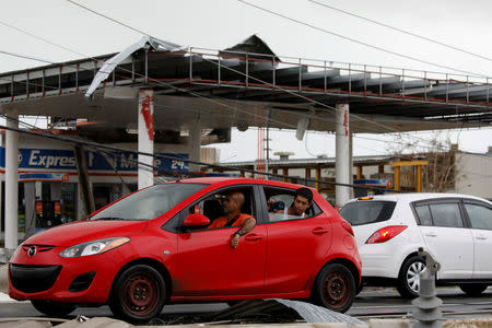 People look at the damage after the area was hit by Hurricane Maria en Guayama, Puerto Rico September 20, 2017. REUTERS/Carlos Garcia Rawlins