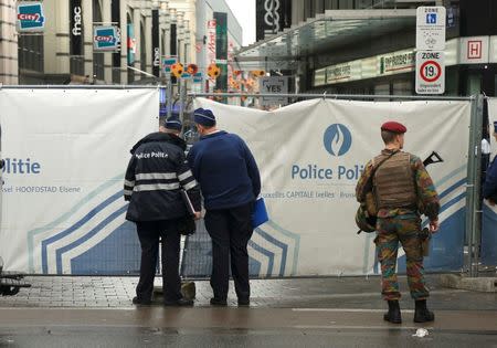 Police and military stand outside the blocked-off street outside the City2 shopping complex which was evacuated following a bomb scare in Brussels, Belgium, June 21, 2016. REUTERS/Francois Lenoir