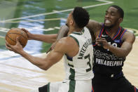 Milwaukee Bucks' Giannis Antetokounmpo is fouled as he drives to the basket against Philadelphia 76ers' Shake Milton during the second half of an NBA basketball game Thursday, April 22, 2021, in Milwaukee. (AP Photo/Aaron Gash)