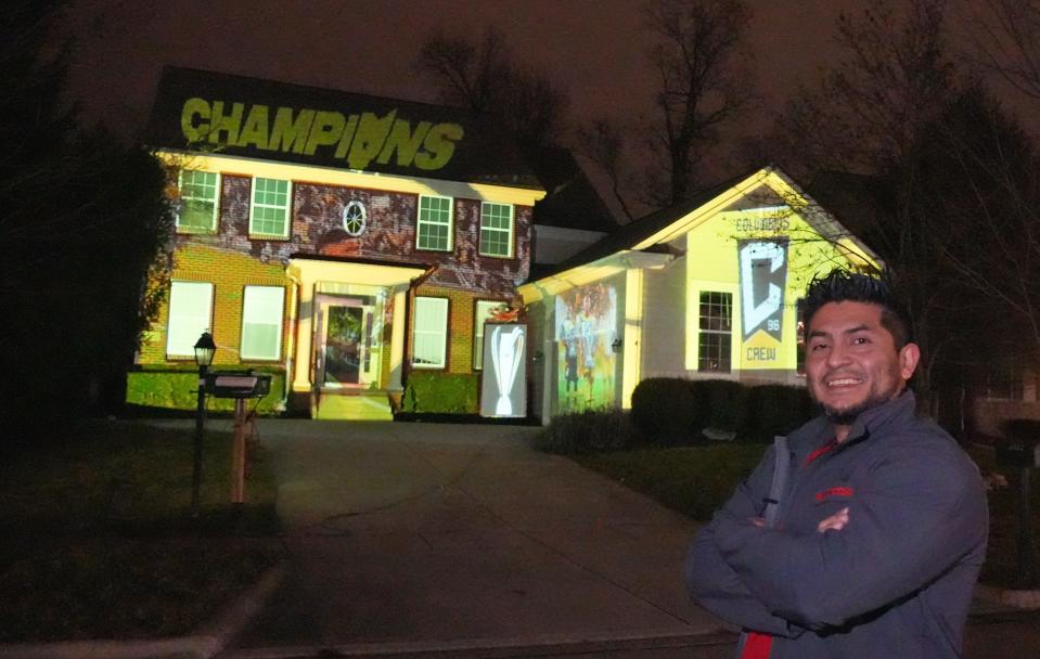 Powell homeowner Edgar Escobar used an old projector to create a Columbus Crew-themed home display.