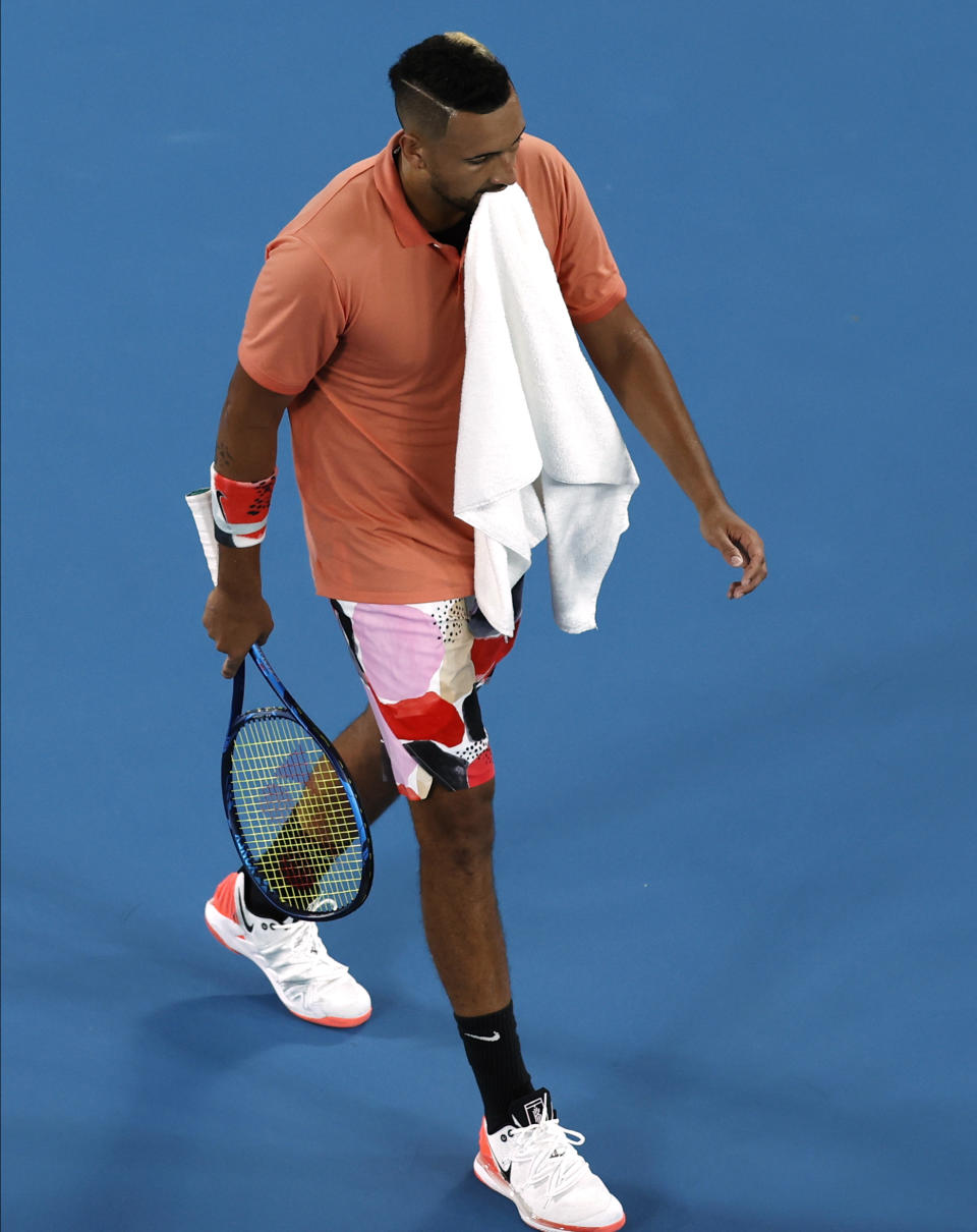 Australia's Nick Kyrgios walks to his chair during his fourth round singles match against Spain's Rafael Nadal at the Australian Open tennis championship in Melbourne, Australia, Monday, Jan. 27, 2020. (AP Photo/Andy Wong)