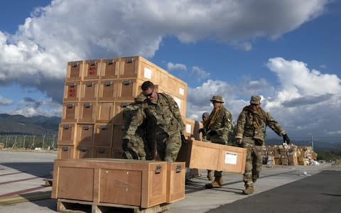 US Air Force officers manage aid supplies at the Mutiara Sis Al Jufri airport in Palu, Indonesia's Central Sulawesi - Credit: YUSUF WAHIL/ AFP 