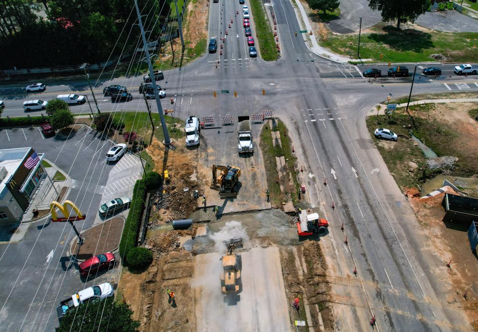 Construction crew works on repairing a large sinkhole on Raeford Road at 71st School Road and Graham Road on Tuesday, June 27, 2023. 