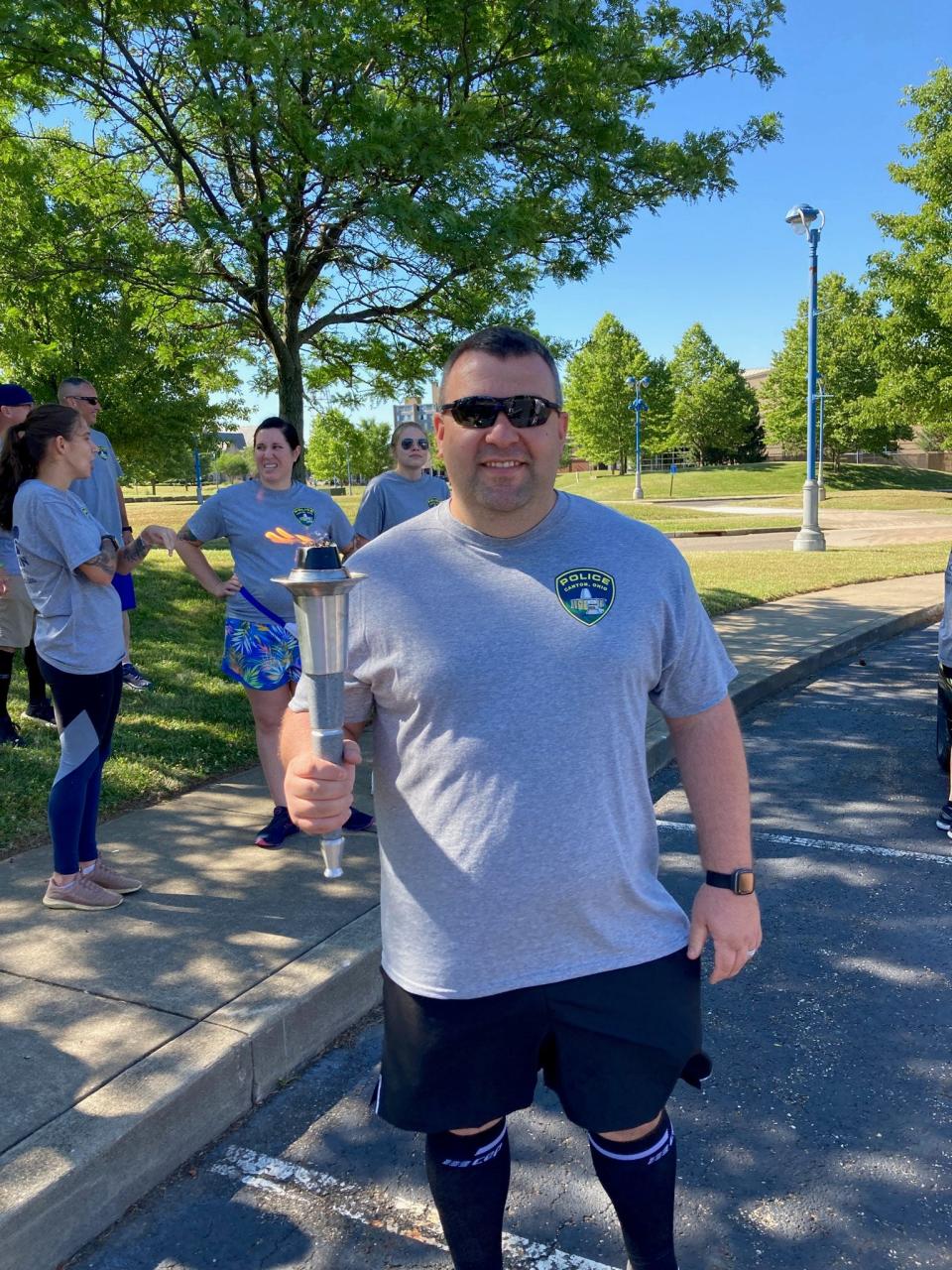 Canton Police Lt. Michael Roberts started and finished Thursday's run carrying the torch during the Law Enforcement Torch Run for Special Olympics through Canton.