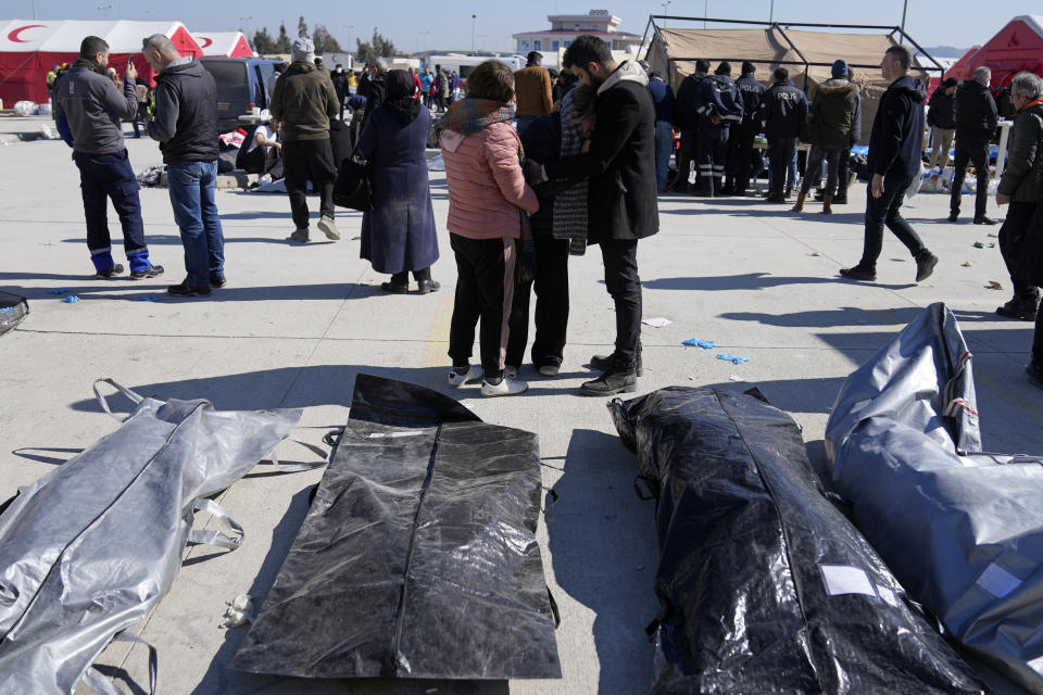 A woman mourns over the bodies of earthquake victims outside a hospital in Antakya, southeastern Turkey, Thursday, Feb. 9, 2023. Thousands who lost their homes in a catastrophic earthquake huddled around campfires and clamored for food and water in the bitter cold, three days after the temblor and series of aftershocks hit Turkey and Syria. (AP Photo/Khalil Hamra)