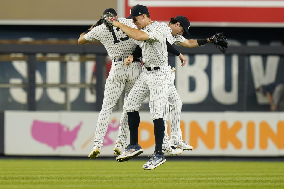 New York Yankees' Aaron Judge, center, Joey Gallo, left, and Tyler Wade, right, celebrate after a baseball game against the Minnesota Twins, Friday, Aug. 20, 2021, in New York. (AP Photo/Frank Franklin II)