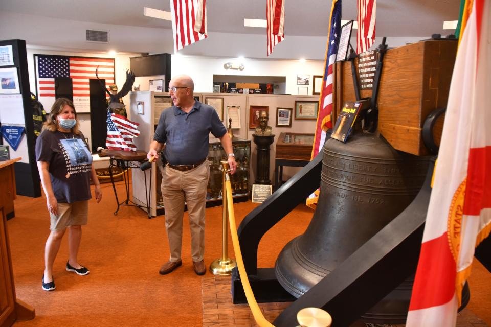 In a May 2021 photo, Rabbi Sanford Olshansky tells the history on the replica Liberty Bell, one of 100 in existence, to Carolyn Sabinksy before he gives her the mallet to ring the bell. She was visiting the museum with her family. The Liberty Bell Museum is gearing up for a big Memorial Day celebration on May 30, 2022.