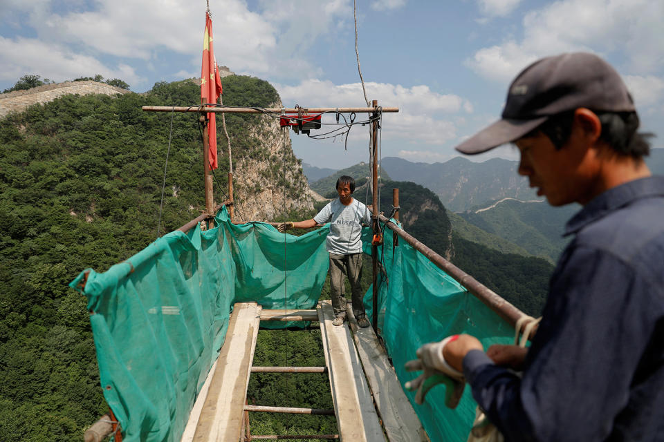 <p>People wait for bricks and other equipment to be delivered as they work on the reconstruction of the Jiankou section of the Great Wall, located in Huairou District, north of Beijing, China, June 7, 2017. (Photo: Damir Sagolj/Reuters) </p>