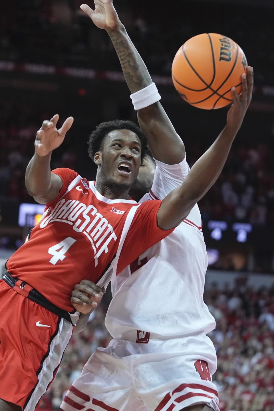 Ohio State's Dale Bonner shoots past Wisconsin's AJ Storr during the first half of an NCAA college basketball game Tuesday, Feb. 13, 2024, in Madison, Wis. (AP Photo/Morry Gash)