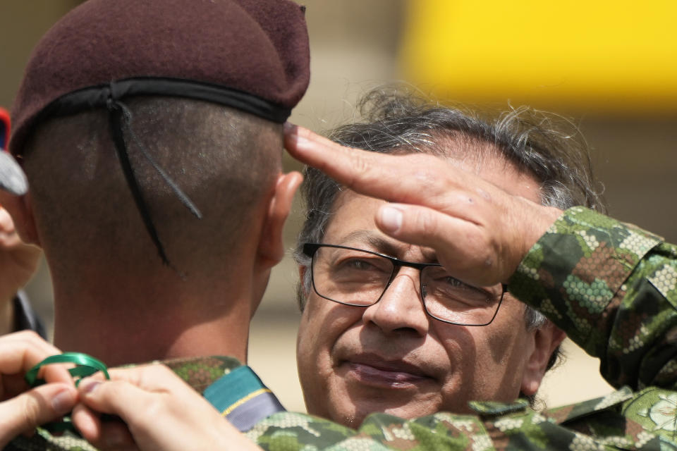 Colombia's President Gustavo Petro decorates a soldier that participated in the search of four Indigenous children who survived an Amazon plane crash, during a ceremony at the Palace of Narino in Bogota, Colombia, Monday, June 26, 2023. (AP Photo/Fernando Vergara)