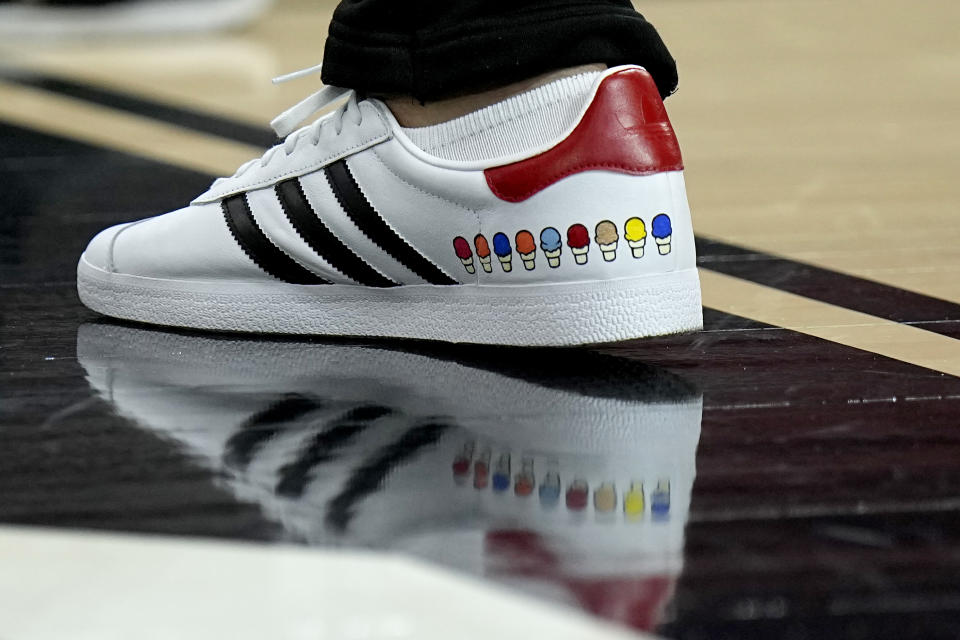 NC State head coach Kevin Keatts wears custom stitched shoes during practice ahead of a Final Four college basketball game in the NCAA Tournament, Friday, April 5, 2024, in Glendale, Ariz. North Carolina State plays Purdue. (AP Photo/Brynn Anderson )