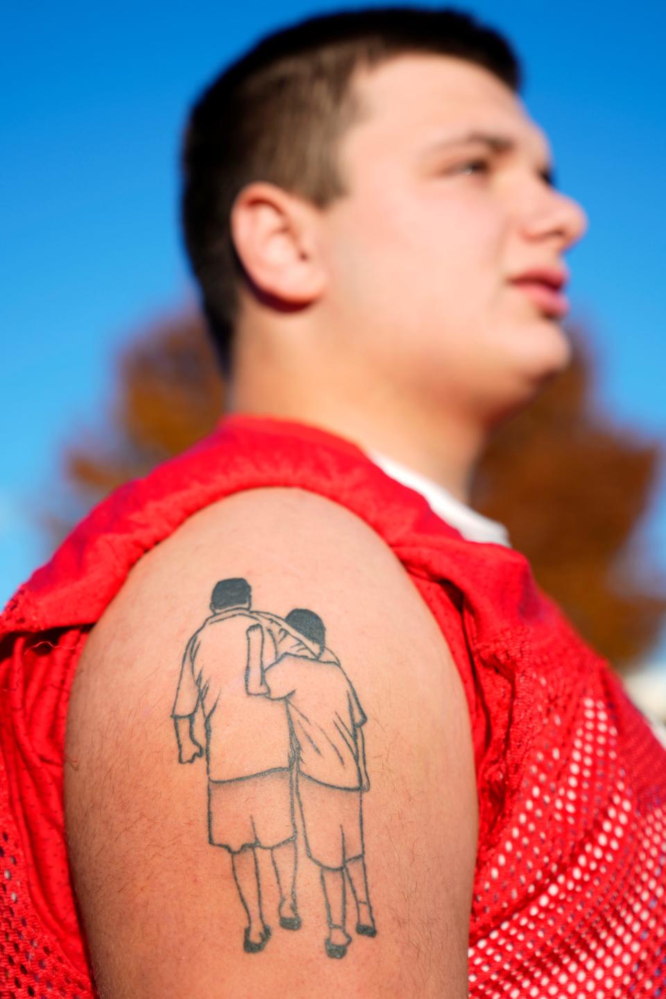 RJ Ussher, of the Westwood High School Football Team, is shown with his tattoo of him alongside his father. Ussher's father died in 2020 from COVID. Tuesday, November 14, 2023