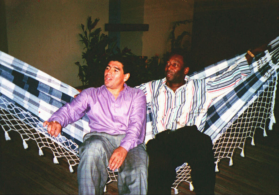 FILE - Argentine soccer star Diego Armando Maradona, left, rests in a hammock with Brazilian soccer star Pele, during a meeting in Rio de Janeiro, Brazil, May 13, 1995. Pelé, the Brazilian king of soccer who won a record three World Cups and became one of the most commanding sports figures of the last century, died in Sao Paulo on Thursday, Dec. 29, 2022. He was 82. (AP Photo/G. Copolla, File)