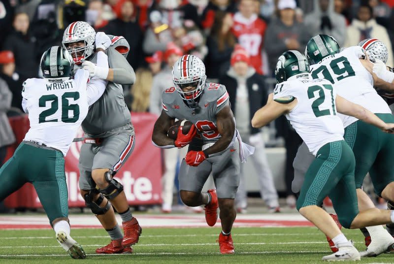 Ohio State Buckeyes running back Chip Trayanum (C) runs against the Michigan State Spartans on Saturday in Columbus, Ohio. Photo by Aaron Josefczyk/UPI