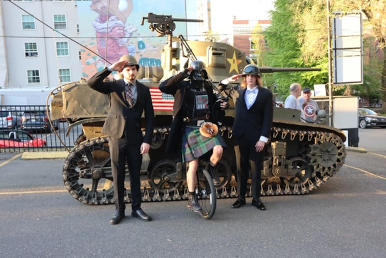 Sam Tetro, left, The Uniper, center, and Sherman Bynum, right, in front of the M3A1 Stuart tank