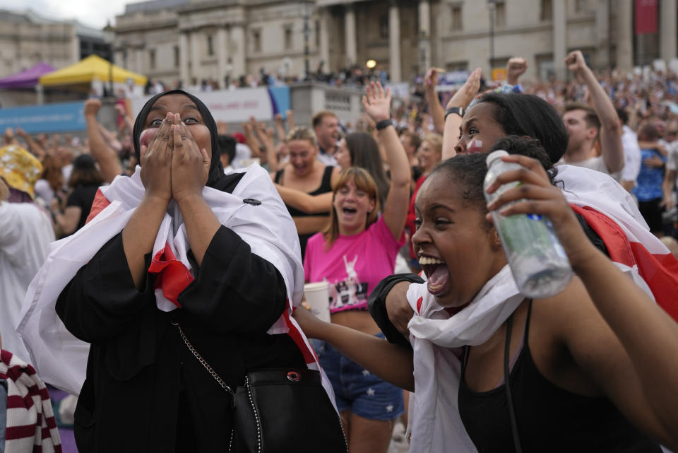 England supporters celebrate after Ella Toone scored the opening goal as they gather in the fan zone in Trafalgar Square to watch on a big screen the final of the Women's Euro 2022 soccer match between England and Germany being played at Wembley stadium in London, Sunday, July 31, 2022. (AP Photo/Frank Augstein)