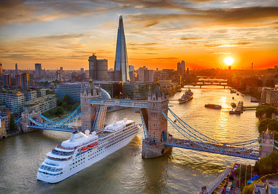 The Silver Wind cruise ship passes under Tower Bridge on its way out of London on a balmy August evening.