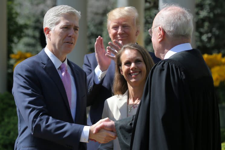 Gorsuch shakes hands with Justice Anthony Kennedy after being sworn as his wife, Louise Gorsuch, and President Trump look on. (Carlos Barria/Reuters)