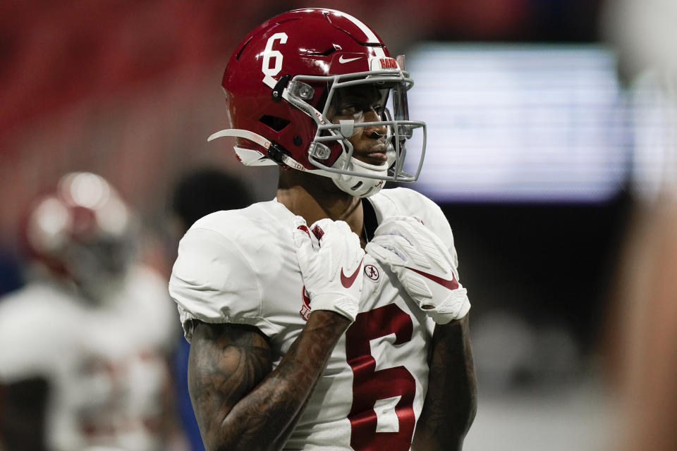 Alabama wide receiver DeVonta Smith (6) warms up before the first half of the Southeastern Conference championship NCAA college football game against Florida, Saturday, Dec. 19, 2020, in Atlanta. Heisman Trophy finalists Mac Jones and DeVonta Smith have been selected to The Associated Press All-America team, Monday, Dec. 28, 2020, leading a contingent of five Alabama players on the first-team offense. (AP Photo/Brynn Anderson)