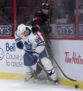 Toronto Maple Leafs center John Tavares knocks Ottawa Senators defenceman Thomas Chabot off the puck during the first period of an NHL hockey game in Ottawa, Ontario, Saturday, Jan. 16, 2021. (Adrian Wyld/The Canadian Press via AP)