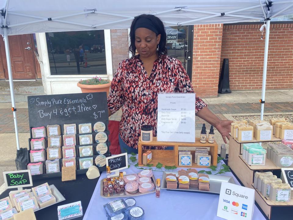 Monica Bond shows her handmade body care products at the Canton Farmers Market in downtown Canton. The market is open each Saturday through Oct. 7.