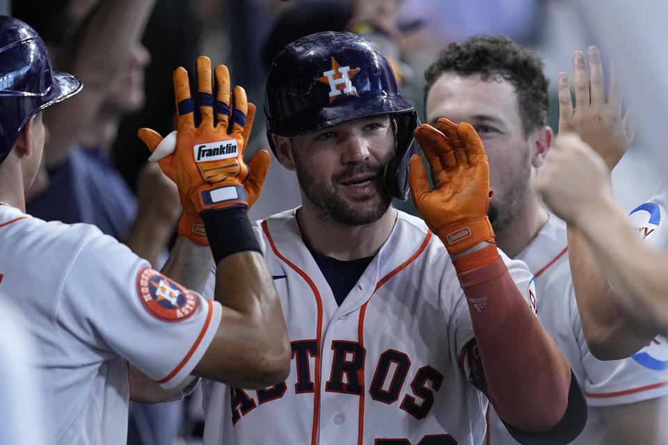 Houston Astros' Chas McCormick is congratulated in the dugout after hitting a two-run home run during the second inning of a baseball game against the Cleveland Guardians, Wednesday, Aug. 2, 2023, in Houston. (AP Photo/Kevin M. Cox)