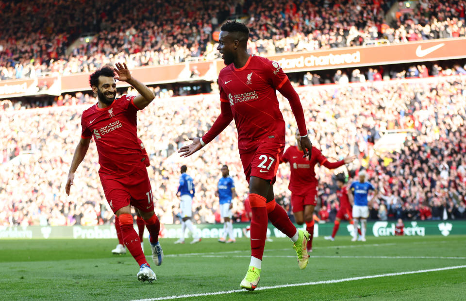 Liverpool forward Divock Origi (right) celebrates with teammate Mohamed Salah after scoring against Everton at Anfield.