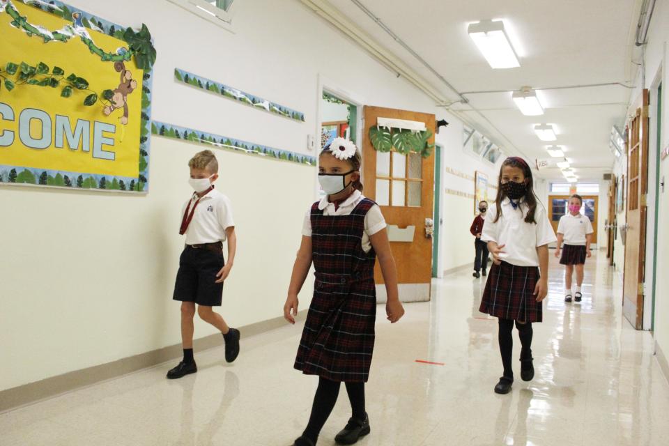 Reverend George A. Brown Memorial School second grade students walk the hallways in their masks on their first day of school Tuesday, Sept. 1.