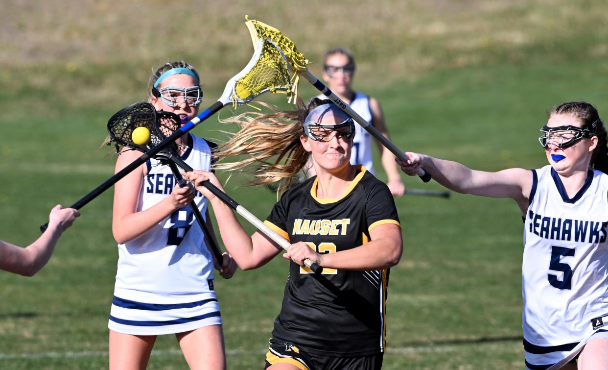 Sienna Reeves of Nauset prepares to fire a shot on goal between Elle Murray (5) and Emelie Jonsson of Cape Cod Academy.