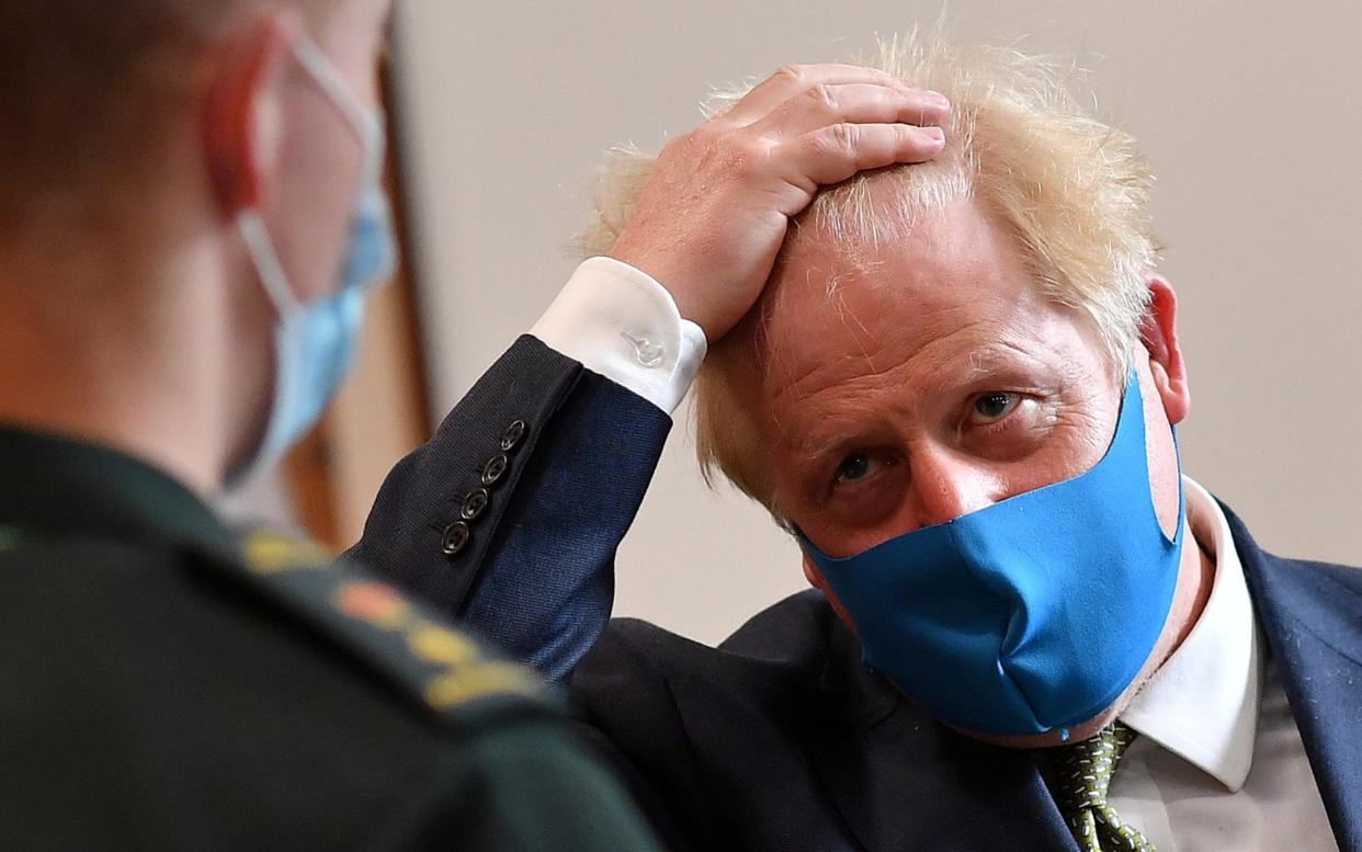 Boris Johnson wears a face mask as he he visits the London Ambulance Service NHS Trust in London - Reuters
