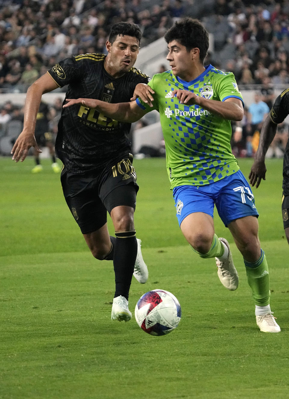 Seattle Sounders midfielder Obed Vargas, right, moves the ball as Los Angeles FC forward Carlos Vela defends during the first half of a Major League Soccer match Wednesday, June 21, 2023, in Los Angeles. (AP Photo/Mark J. Terrill)