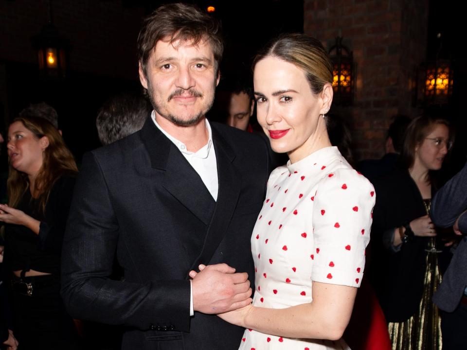 Pedro Pascal and Sarah Paulson holding hands