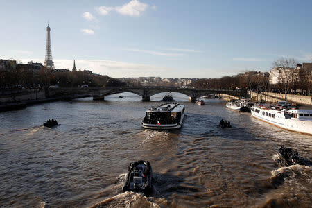 The 'Mirage' boat (C) transporting the French President and heads of State and government is seen on the Seine river in Paris on its way to the Ile Seguin near Paris as part of the One Planet Summit, France, December 12, 2017. REUTERS/Yoan Valat/Pool