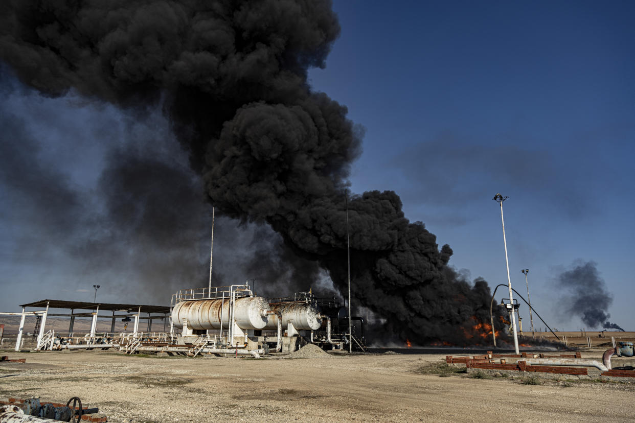 A smoke rises from an oil depot struck by Turkish air force near the town of Qamishli, Syria, Wednesday, Nov. 23, 2022. Turkey's president says he will carry out a land invasion into Kurdish areas of northern Syria. Recep Tayyip Erdogan's statement in Ankara Wednesday came after Turkey carried out a barrage of airstrikes on suspected Kurdish militants in northern Syria and Iraq in recent days. (AP Photo/Baderkhan Ahmad)