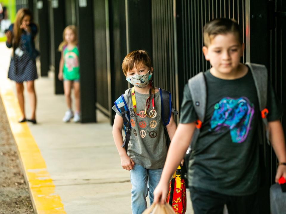 Sophia Bentley, 5, a Shady Hill Elementary School kindergarten student, makes her way to the classroom after parents dropped her off for the first day of school.