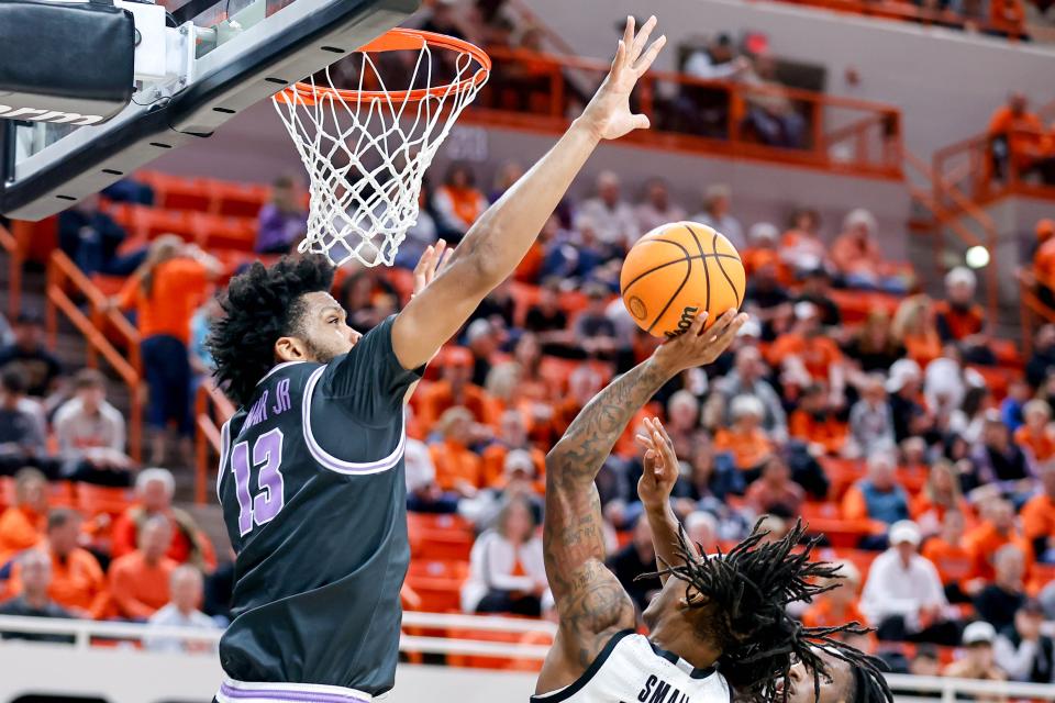 Kansas State forward Will McNair(13) blocks a shot by Oklahoma State's Javon Small (12) during Saturday's game at Gallagher-Iba Arena in Stillwater Okla.