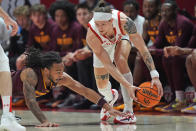 Arizona State guard Frankie Collins, left, dives for the ball held by Utah guard Gabe Madsen during the first half of an NCAA college basketball game Saturday, Feb. 10, 2024, in Salt Lake City. (AP Photo/Rick Bowmer)