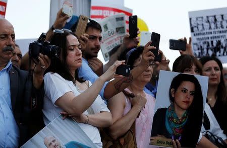 Journalists and press freedom activists take pictures and videos during a demonstration in solidarity with the members of the opposition newspaper Cumhuriyet who were accused of supporting a terrorist group outside a courthouse, in Istanbul, Turkey, July 24, 2017. REUTERS/Murad Sezer