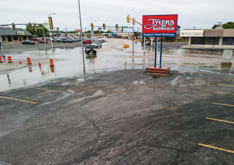 Barricades are set up on Paramount Boulevard during flash flooding Friday in Amarillo. The storm dumped rain for hours on the city, leading to several road closures.