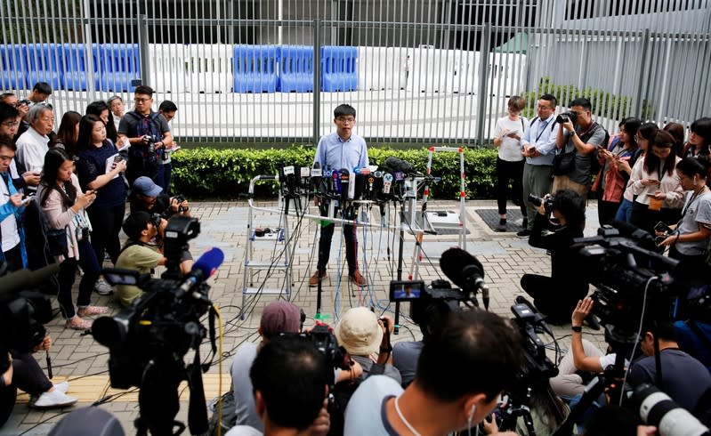 Pro-democracy activist Joshua Wong speaks to journalists after being disqualified from running in local district's council elections in November, in Hong Kong