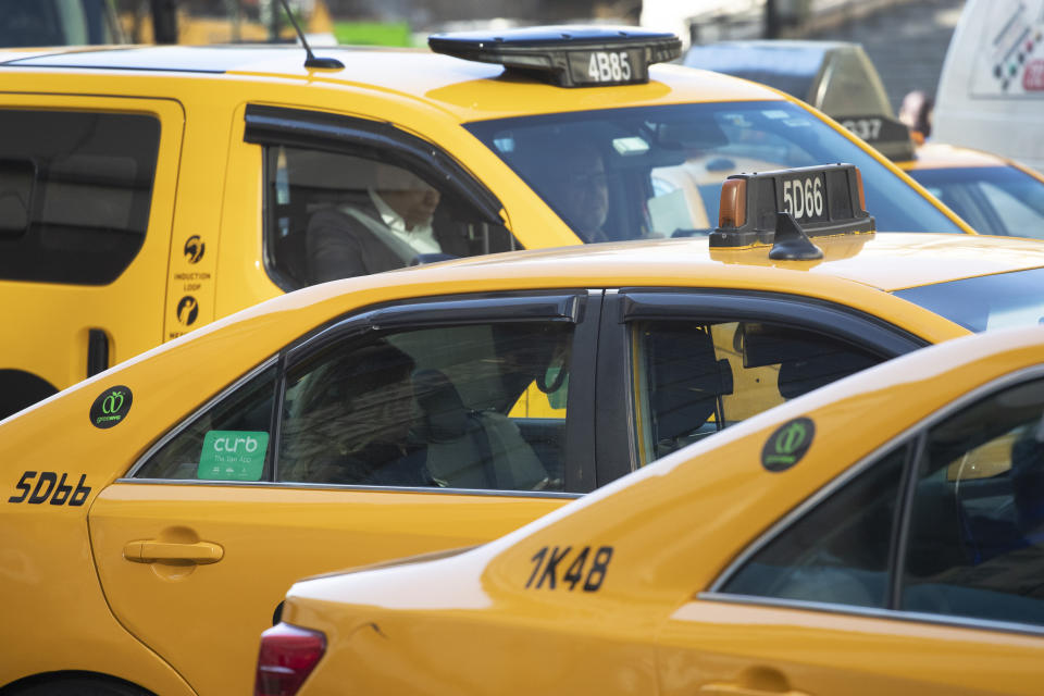 HOLD FOR STORY BY KAREN MATTHEWS - Taxis are lined up in traffic, Wednesday, Jan. 29, 2020, in New York. A task force studying New York City's struggling taxi industry called Friday for “mission-driven” investors to help bail out drivers who incurred massive debt once the value of the medallion that allows a person to operate a yellow cab plummeted in the age of Uber and Lyft. (AP Photo/Mark Lennihan)